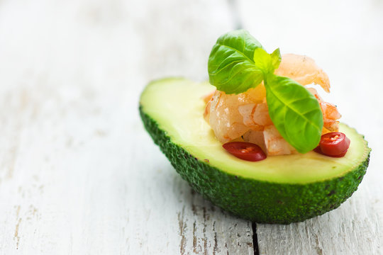 Avocado And Prawns With Chilli On A Wooden Background