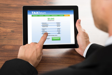 Businessman Filling Tax Return Form