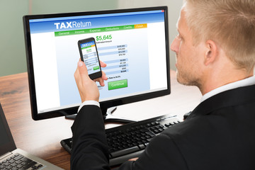 Businessman Looking At Online Tax Return Form