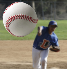 Closeup of a baseball being pitched.