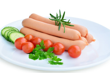 Sausages and vegetables on white plate isolated