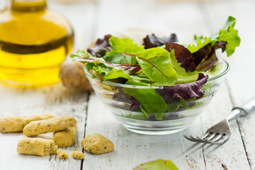 Summer salad in a cup on a wooden background