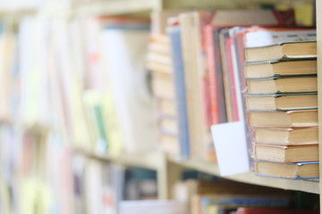 The image of books on the shelf in a library. 