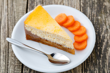 Sweet slice of carrot cake on white plate.