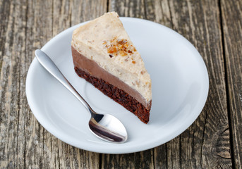 Tasty nuts cake on wooden background.