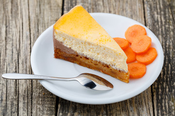 Sweet slice of carrot cake on white plate.
