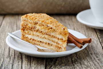 Tasty honey cake on wooden background.