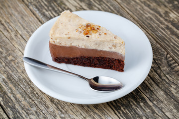 Tasty nuts cake on wooden background.