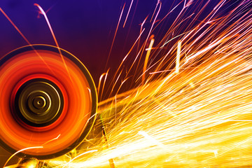 Sparks from circular saw. Metal sawing close up.