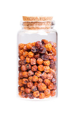 Dry rowan in a bottle with cork stopper for medical use.