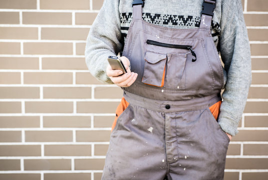 Anonymous Handyman With Mobile Phone, 24/7 Help Concept