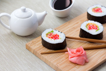 Sushi rolls with ginger, soy sauce and chopsticks