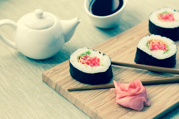 Sushi rolls with ginger, soy sauce and chopsticks