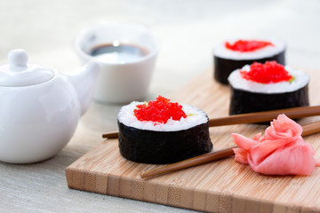 Sushi rolls with ginger, soy sauce and chopsticks