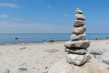 Balanced stones stacked to a tower on the beach of the Baltic Se