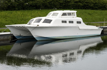 small catermaran type boat  on a canal