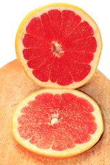 Fototapeta na wymiar pieces of grapefruit on the board isolated
