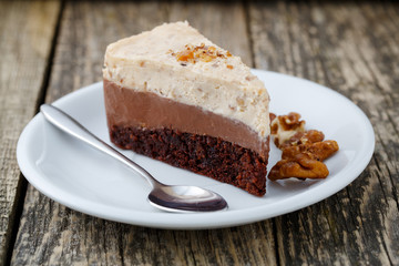 Tasty nuts cake on wooden background.