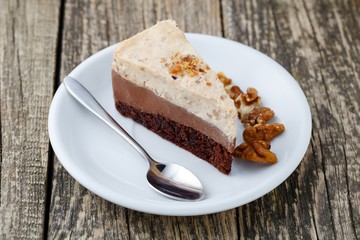 Tasty nuts cake on wooden background.