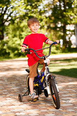 Smiling little boy riding bike