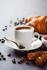 Fresh croissants  and cup of coffee on a table