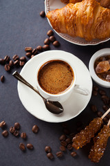 Fresh croissants  and cup of coffee on a table