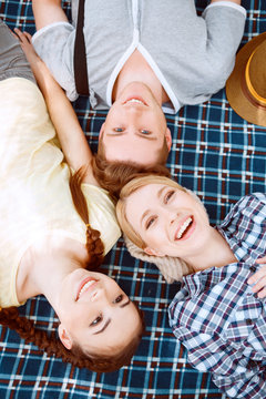 Happy young people lying on cover 