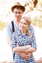 Fototapeta premium Young man embracing his girlfriend 