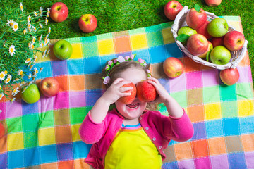 Fototapeta na wymiar Little girl eating apples
