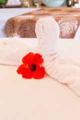 Fototapeta na wymiar Towel decoration on massage table. Spa interior