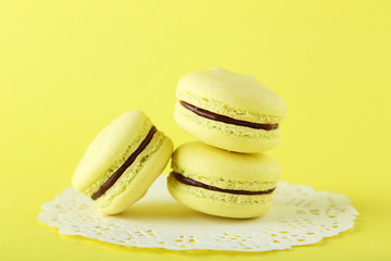 French macarons on yellow background