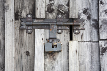 Fragment of wooden door with a key lock.
