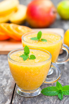 fresh healthy pulpy juice with orange fruits and vegetables