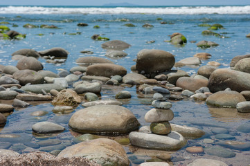 Delicately stack of rocks balanced in the tide pool