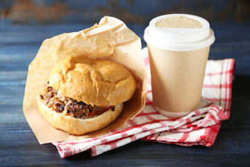 Tasty burgers on wooden table background, close-up. Unhealthy food concept