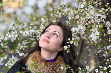 girl on nature among flowering trees