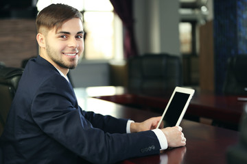 Businessman working with tablet in office