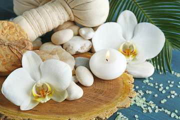 Fototapeta na wymiar Still life with beautiful blooming orchid flower, spa treatment on wooden background