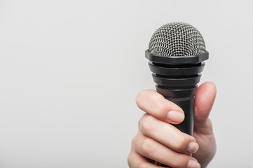  microphone is hold by girl tv journalist