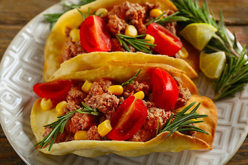 Mexican food Tacos in plate on wooden table, closeup