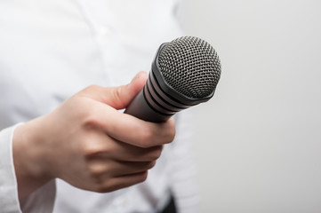 microphone is hold by girl tv journalist