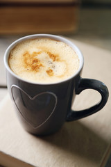 Still life with cup of coffee and book, close up