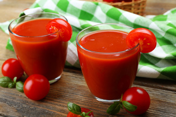 Glasses of tomato juice with vegetables on table close up
