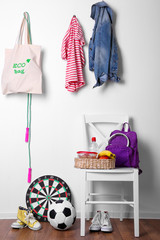 Children things hanging on wall and stacked in room