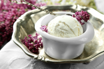 Beautiful composition with tasty ice cream and lilac flowers