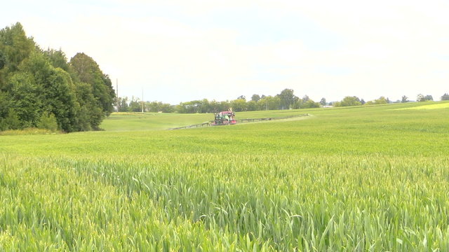 farmer spray crop field at summer season, herbicides, pesticides