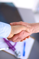Doctor shakes hands with a patient 