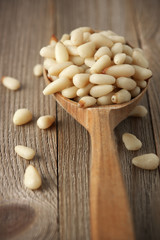 Pine nuts in wooden spoon