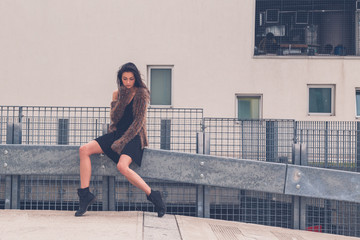 Beautiful girl posing in an urban context