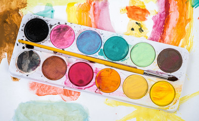 Watercolors and paintbrush. Top view.